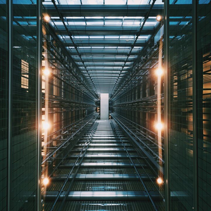 Photo of grey building including computer walls