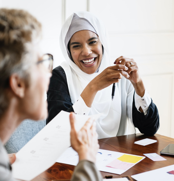 Women at a meeting smiling